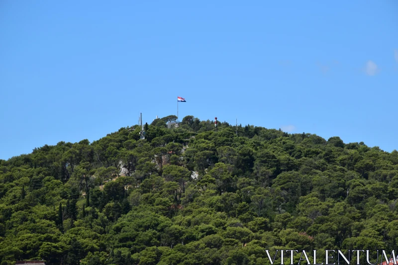 Scenic Croatian Hilltop with National Flag Free Stock Photo