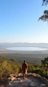 Man in African-inspired Landscape: Captivating View of Mountains and Lake