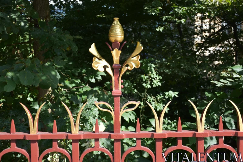 Decorative Ironwork Against Greenery Free Stock Photo