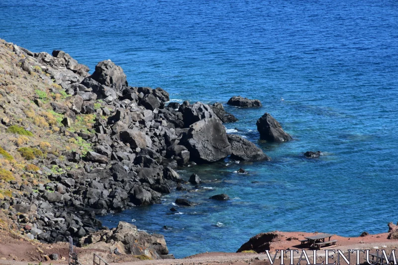 Rocky Shoreline and Vibrant Ocean Waters Free Stock Photo