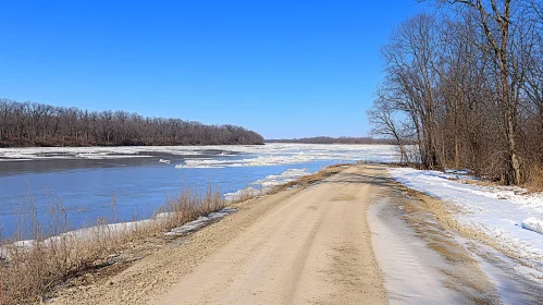 Tranquil Frozen River and Snowy Trail Scene