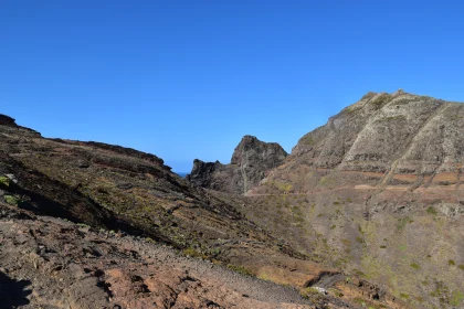 Rugged Mountain Terrain Under Blue Sky