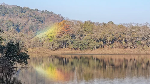 Tranquil Lake with Forest and Rainbow Reflection