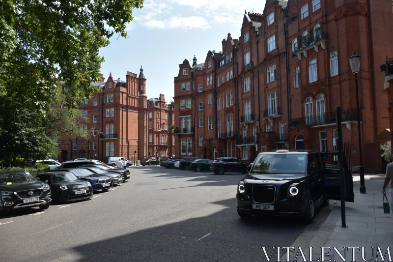 Brick Building Lined Street with Classic Taxi Free Stock Photo