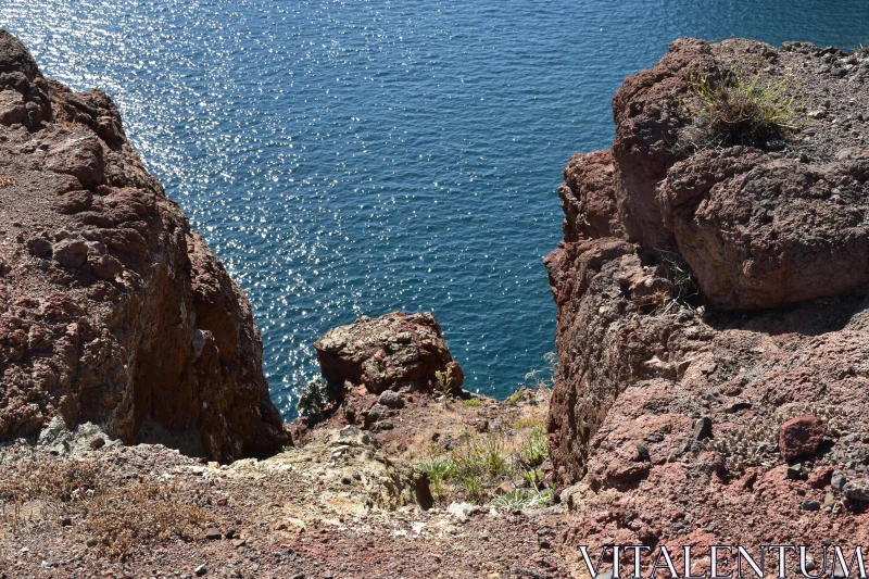 Rugged Cliffside Overlooking Blue Ocean Free Stock Photo