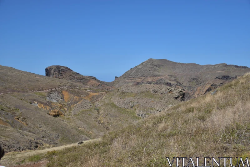 PHOTO Rugged Mountainous Terrain with Blue Sky