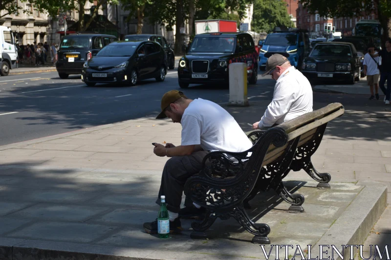 Men Sitting in Urban Setting Free Stock Photo