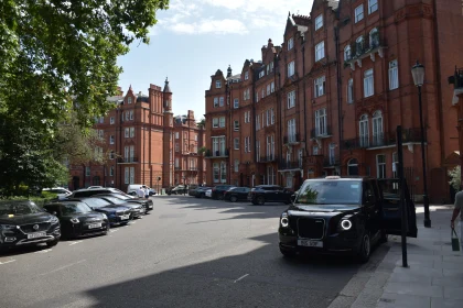 Brick Building Lined Street with Classic Taxi