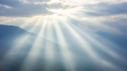 Sun Beams Over Mountain Landscape