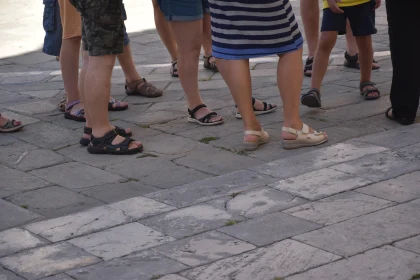 Feet of Urban Dwellers on Pavement