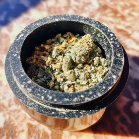 Marble Herb Grinder Filled with Crushed Herbs