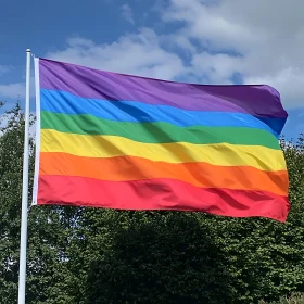 Rainbow Pride Flag Against Blue Sky