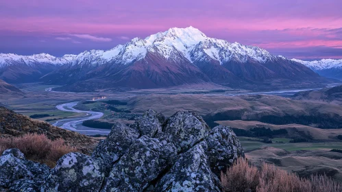 Sunset Over Snow-Capped Mountains and Serene Valley