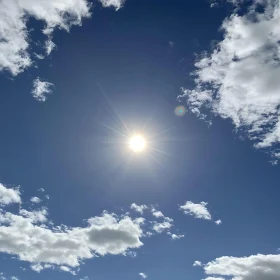Celestial Sky with Sun and Clouds