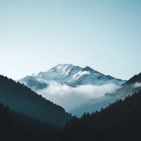 Snowy Mountain Peak Above Misty Valley