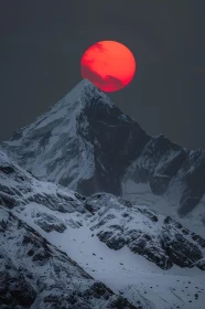 Snowy Peaks under a Crimson Sun