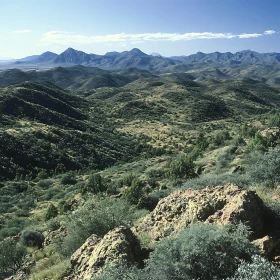 Verdant Hills and Distant Peaks