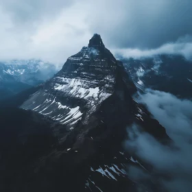 Snow-Capped Mountain Ascending into Cloudy Skies