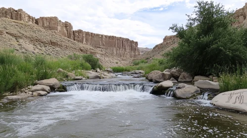 Peaceful River Scene with Cliffs and Waterfall