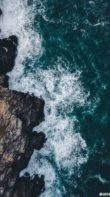 Top-Down View of Rocky Shoreline with Ocean Waves