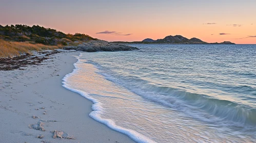 Tranquil Beach at Sunset with Ocean Waves and Horizon Mountains