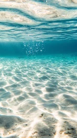 Serene Underwater Ocean with Sunlit Sand and Ripples