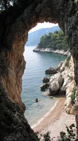 Serene Mediterranean Scene Framed by Rocky Arch