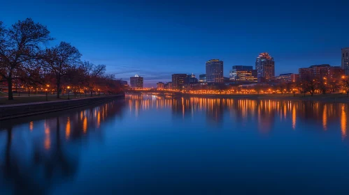 Illuminated Urban Skyline Reflected in Tranquil Waters at Night