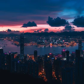 Illuminated City Skyline Against a Sunset