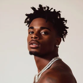 Young Man with Coiled Hair and Chains
