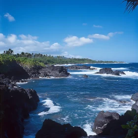 Tropical Coastline with Black Rocks and Blue Waves