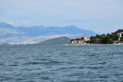 Tranquil Coastal View with Church and Mountains