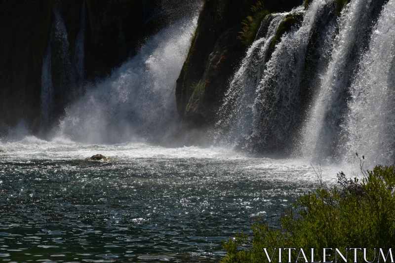 PHOTO Serene Waterfall and River with Sunlit Mist