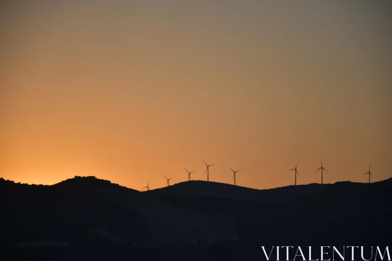 PHOTO Windmill Silhouettes Against Sunset