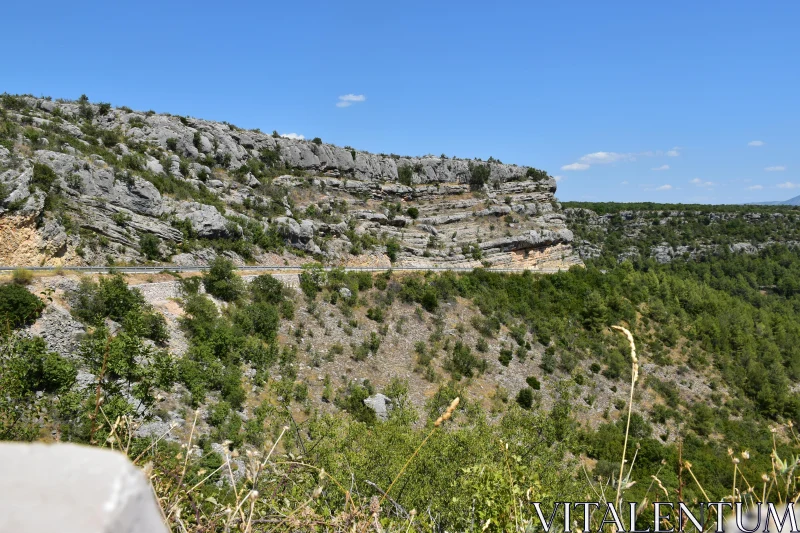 PHOTO Rugged Cliffs and Greenery Under Blue Sky