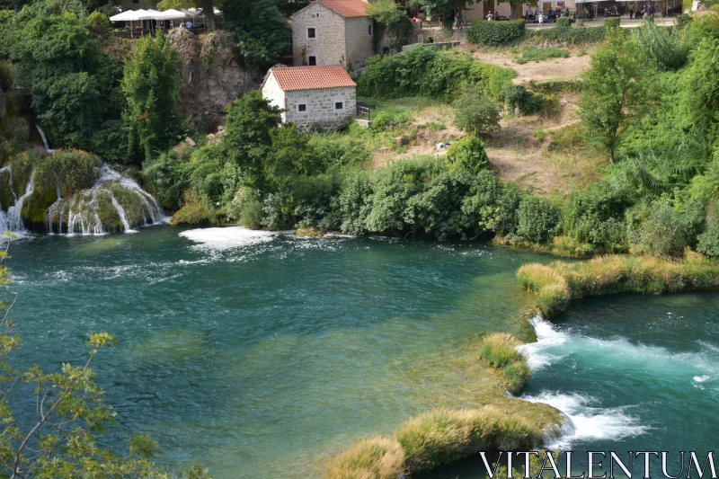 Lush River Scene with Rustic Charm Free Stock Photo