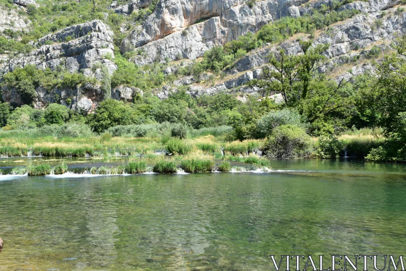 Tranquil River Scene with Cliffs Free Stock Photo