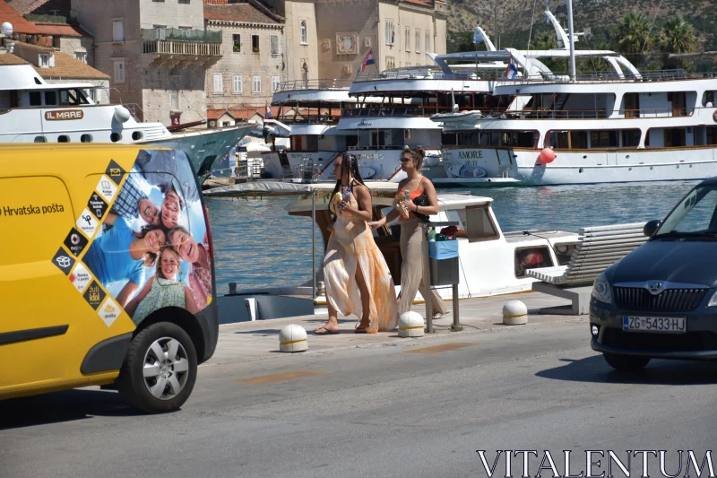 PHOTO Bustling Port with Yachts and Pedestrians