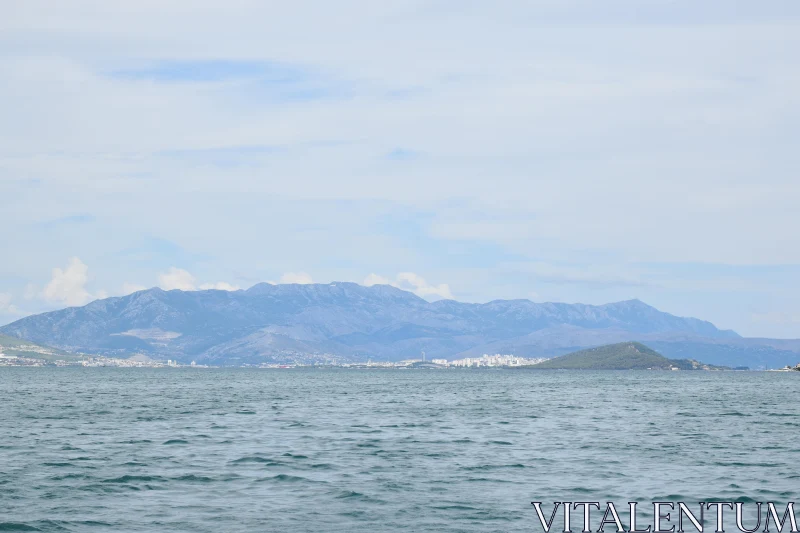 Serene Ocean View with Mountain Range Free Stock Photo