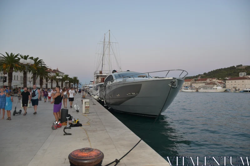 PHOTO Promenade with Yacht in Coastal Urban Setting