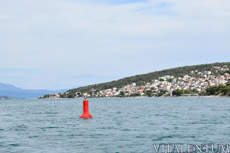 Tranquil Seaside View with Floating Red Buoy Free Stock Photo