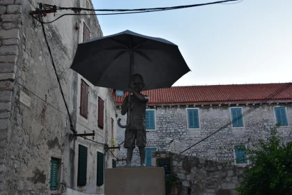 Child Holding Umbrella Sculpture