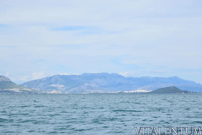 Tranquil Waters and Mountain Horizon Free Stock Photo