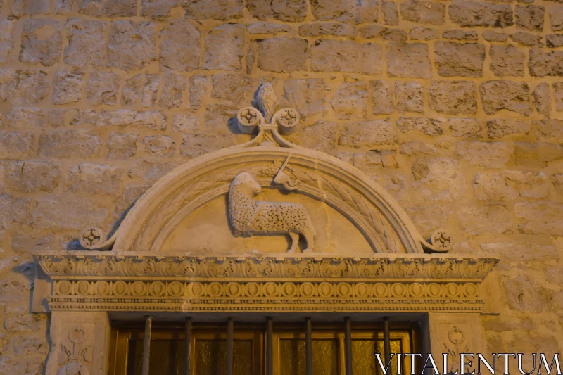 PHOTO Historic Lamb and Cross Relief in Stone