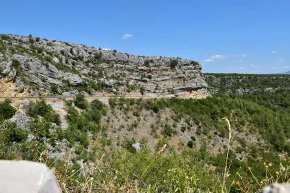 Rugged Cliffs and Greenery Under Blue Sky