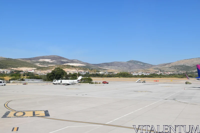 PHOTO Airport Runway and Mountain Landscape