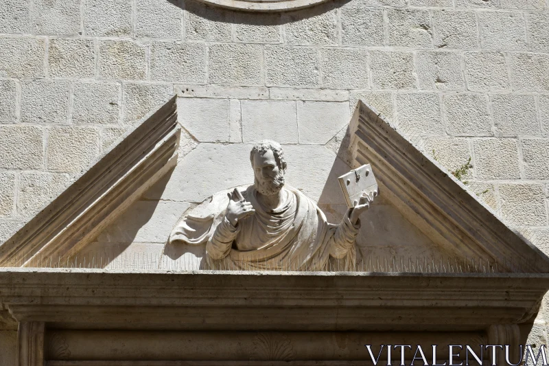 Classical Stone Sculpture with Book Free Stock Photo