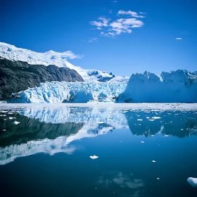 Serene Glacier Scene with Reflective Waters and Majestic Mountains