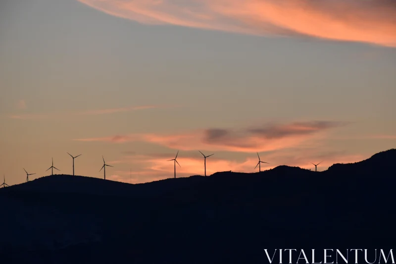 Silhouetted Windmills at Sunset Free Stock Photo