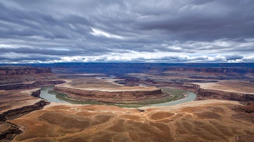 Vast Desert Canyon with River and Cloudy Sky